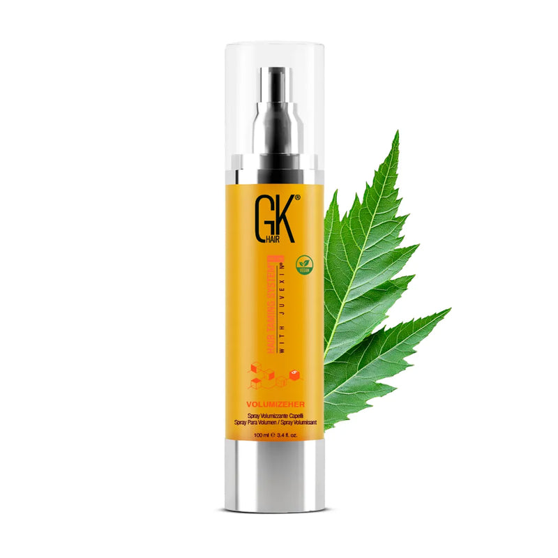 GK Hair VolumizeHer Spray Pro 100 ml orange bottle with clear cap over the pump, front view with a green leaf behind