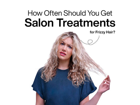 A woman with curly, frizzy hair looks confused, holding a strand. Text above reads, "How Often Should You Get Salon Treatments for Frizzy Hair?