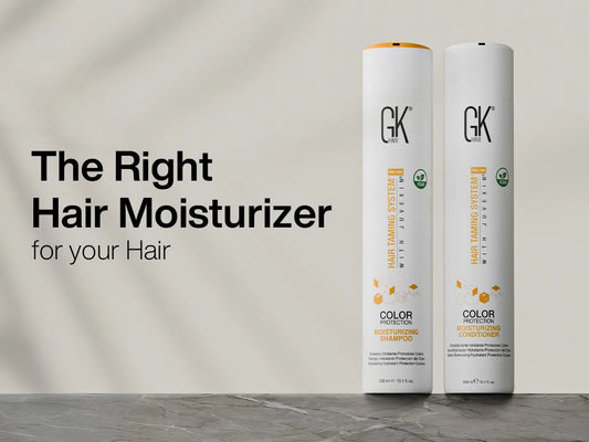 Two tall, white bottles of GK Hair Moisturizing Shampoo and Conditioner on a marble surface next to bold text: "The Right Hair Moisturizer for your Hair." The mood is professional.
