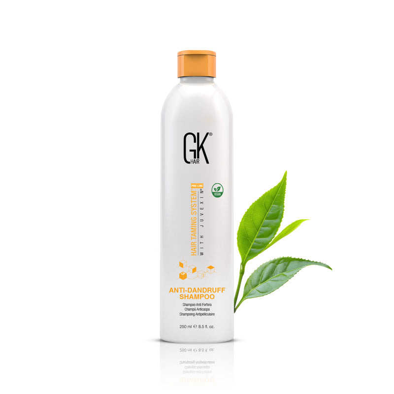 GK Hair Anti-Dandruff Shampoo 250 ml white bottle with orange cap, front view with green leaves