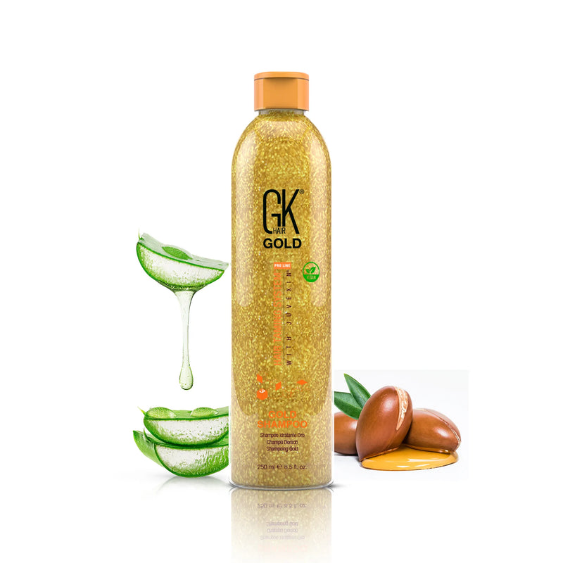 GK Hair Gold Shampoo Pro 250 ml gold-flecked bottle with orange cap, shown with aloe vera slices and argan nuts